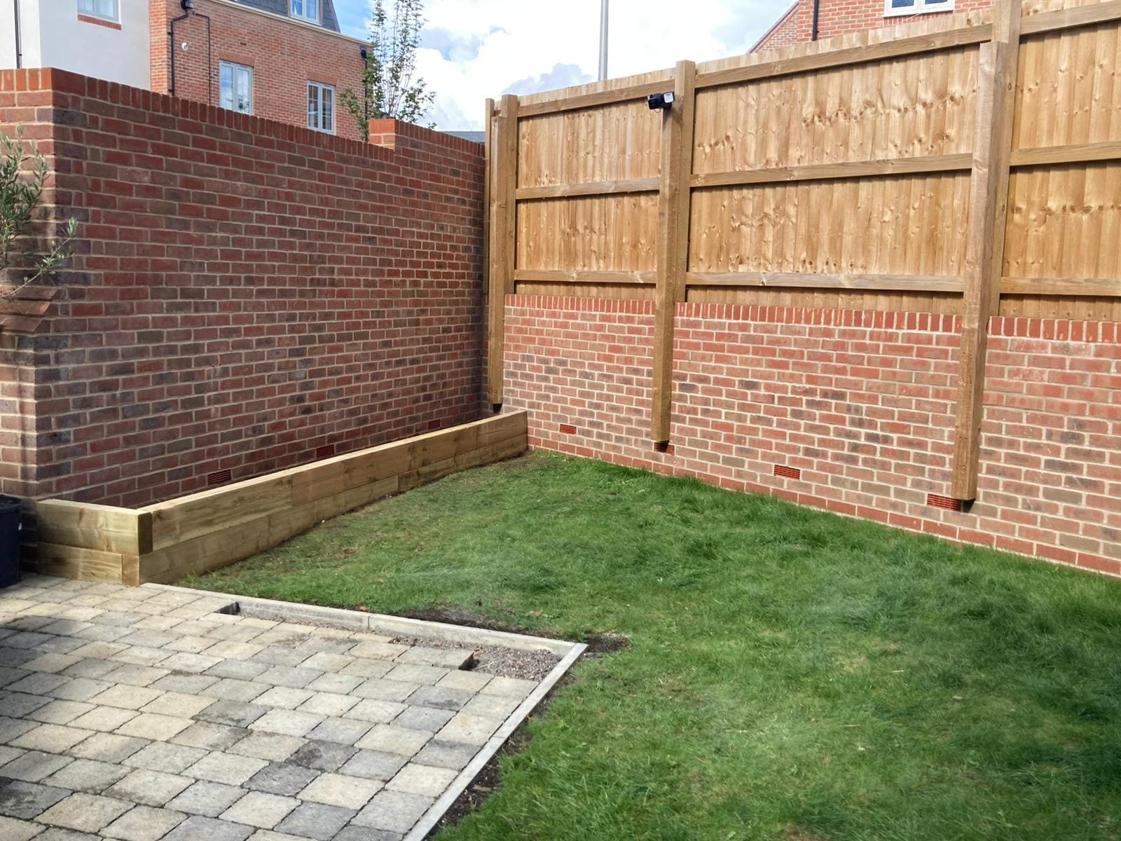 Fresh turf laid and sleeper raised beds built — an instant garden transformation
